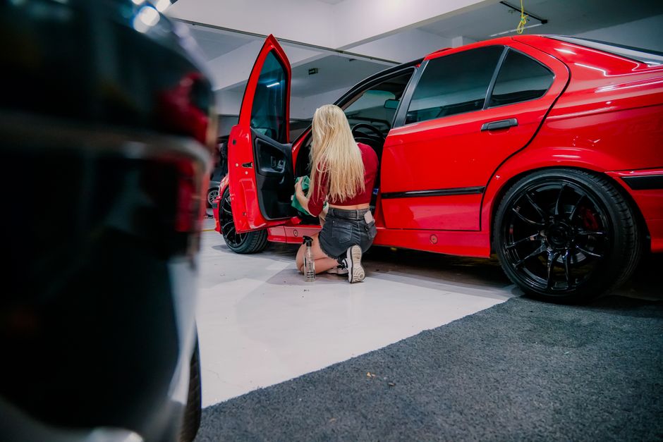 Detailer meticulously cleaning the interior dashboard of a car